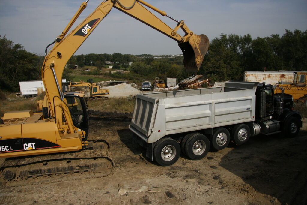 Dirt, sand, gravel or rocks being loaded into dump truck